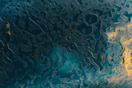 Intricate raindrop patterns forming abstract designs on a window, capturing the natural beauty and complexity of water on glass surfacesの素材