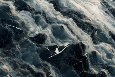 Intricate marble like stone texture showcasing dynamic veining patterns in shades of gray and white, creating a natural and artistic appearanceの素材