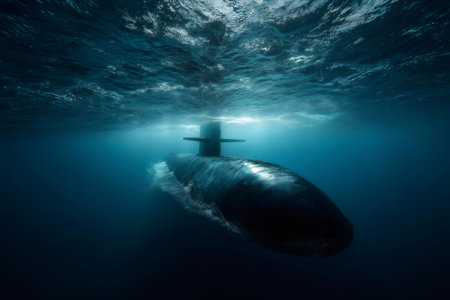Military submarine surfacing from the depths of a dark blue ocean, showcasing advanced technology and the power of naval defenseの素材
