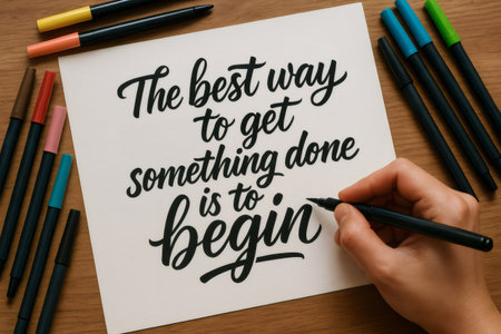 Hand lettering artist creating an inspiring motivational quote using a brush pen on paper, showing creativity and artistic skillの素材