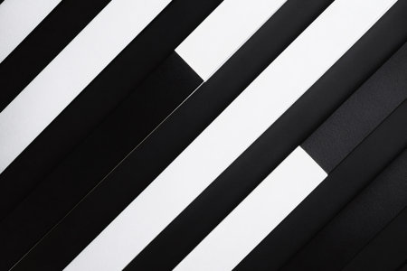 Diagonal black and white stripes create a striking geometric pattern, showing a bold contrast and modern abstract designの素材