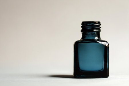 Empty blue ink bottle with cap off, indicating a need for refilling or representing classic stationeryの素材