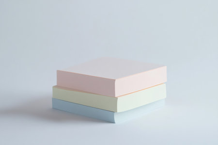 Stack of blank sticky note pads in soft pastel colors, creating a clean minimalist composition with ample copy spaceの素材