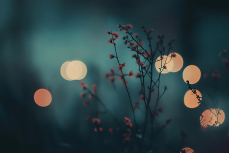Soft focus background with vibrant reddish flowers, creating a serene and dreamy atmosphere with glowing bokeh circlesの素材