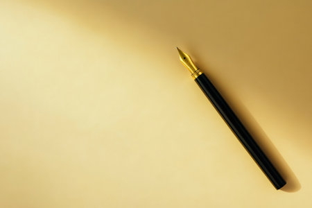 Fountain pen with a golden nib rests on a peaceful beige background, representing literature, business, and eleganceの素材