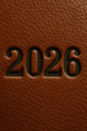 New year 2026 concept. Debossed numerals on textured brown leather surface representing a diary or planner coverの素材
