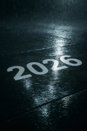 2026 year number painted on a dark, wet asphalt surface with heavy rain falling and creating reflectionsの素材