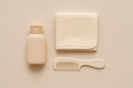 Baby shampoo bottle, soft towel, and comb providing gentle care products for infant hygiene and sensitive skinの素材