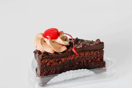 chocolate cake with cherry on white background.