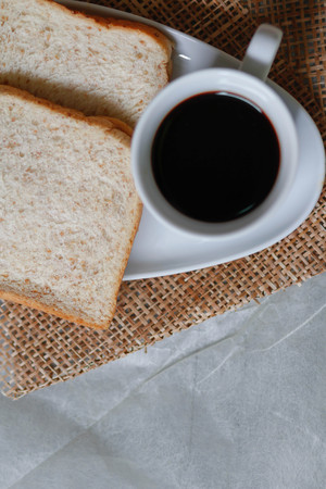 cup of black coffee and Whole wheat breadの写真素材