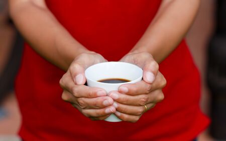 hand holding a cup coffeeの写真素材