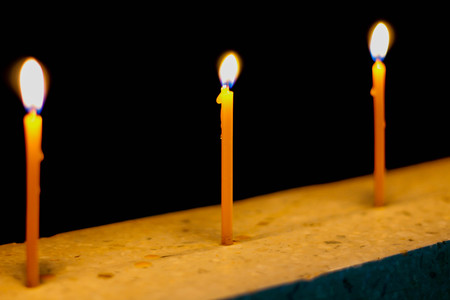 burning candle on the black backgroundの写真素材