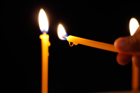 burning candle on the black backgroundの写真素材