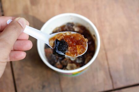 Grass Jelly with syrup in the spoon.の写真素材
