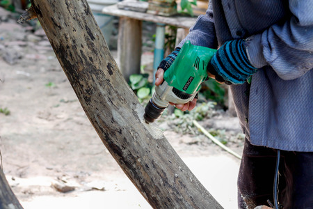 hands holding electric drillの写真素材