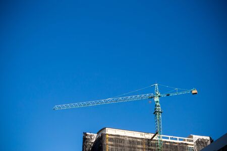 Crane on a building under constructionの写真素材