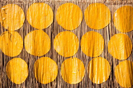 raw giant rice crispy dry on dried cogon grass. giant rice crispy is a traditional dessert of northern thailandの写真素材