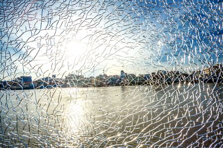 Fractured Mirror on blurred river and city backgroundの写真素材