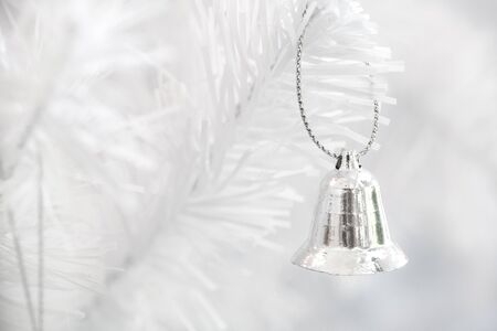 silver bell hang on white christmas tree