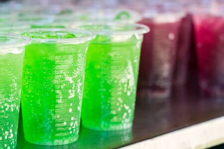 Green beverage in clear plastic glassの写真素材