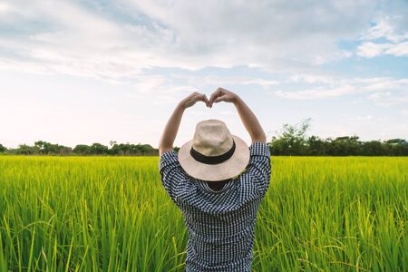 The hand of a farmer girl is made in the shape of a heart to show her love of her career and nature.の写真素材