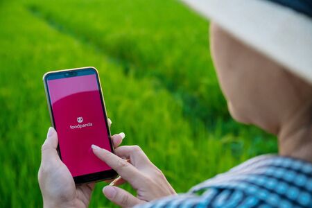 Chiang mai, Thailand - October 16, 2019: Rural women are using the Foodpanda application when she is...