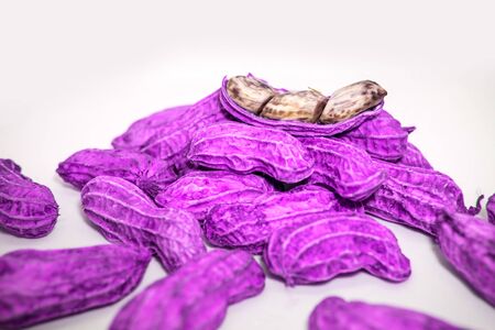 Fantasy. Mutant peanuts are purple, placed on a white background.の写真素材