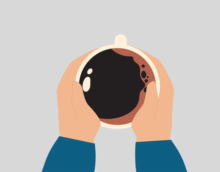 Hands holding a big warm cup of coffee in cold weather seasons. Woman or man holding a big cocoa mug...