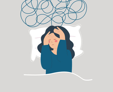Tired woman lying on bed and has difficulty to sleep at night due to headache. Sad girl suffers from insomnia, nightmares and negative tangled thoughts. Concept of Mental health.のイラスト素材