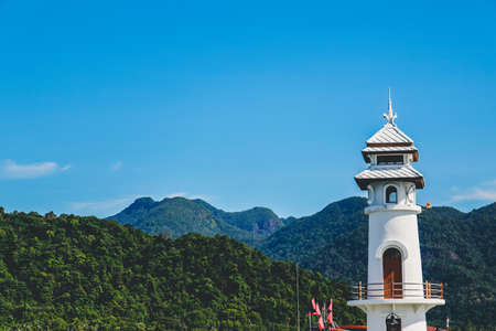 Lighthouse with mountain and clear sky