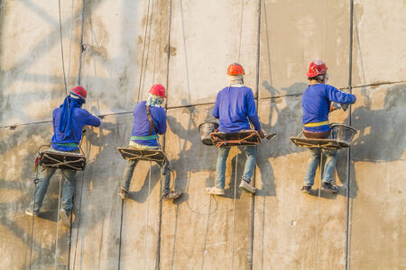 Bricklayer working on the high buildingの写真素材
