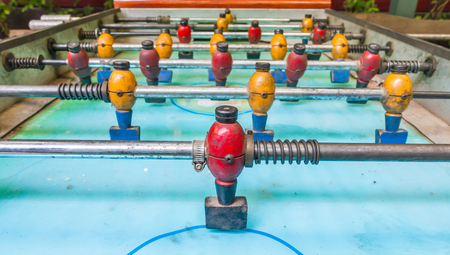 Old table football or soccer, with yellow and red players.