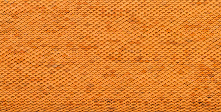 Orange roof top tiles on temple at thailandの写真素材