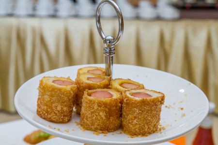 Appetizer, Bread roll with sausage on white plate.の写真素材