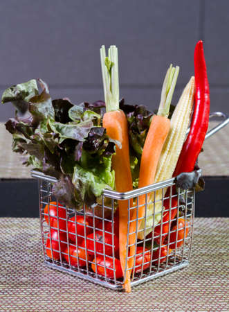 Vegetable in iron basket on the tableの写真素材