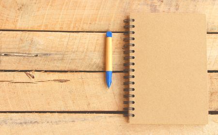 Notebook on wooden tableの写真素材