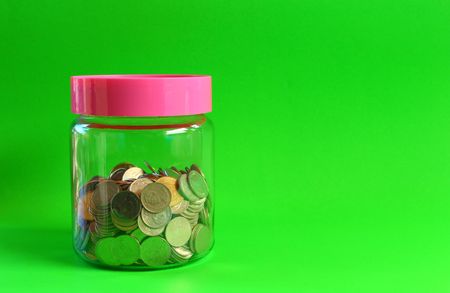 Money in a glass with a green background.の写真素材