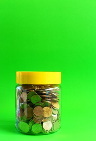 Money in a glass with a green background.の写真素材