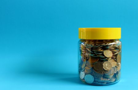 Money in a glass with a blue background.の写真素材