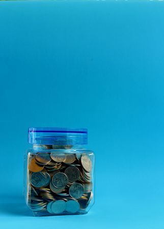 Money in a glass with a blue background.の写真素材
