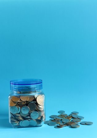 Money in a glass with a blue background.の写真素材