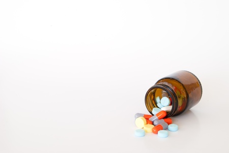 Pills pouring out of the brown bottle の写真素材