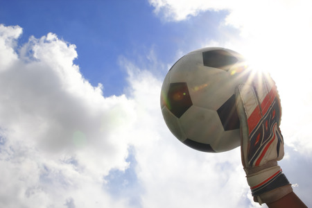 Soccer goalkeeper s hands reaching for the ballの写真素材