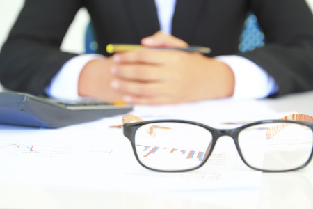 photo of a businessman analyzing financial data focus on grass の写真素材