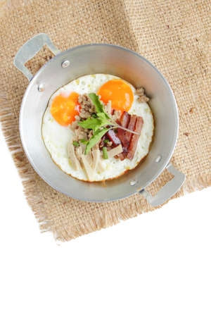 Healthy breakfast - fried eggs, ham, bacon, pork in the pan and breadの写真素材