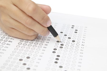 Standardized test form with answers bubbled in and a pencil, focus on anser sheetの写真素材