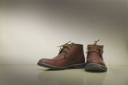 Pair of old brown working bootsの写真素材