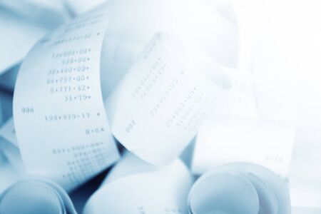 Paper cash register receipts in a lose pile close up with soft focusの写真素材