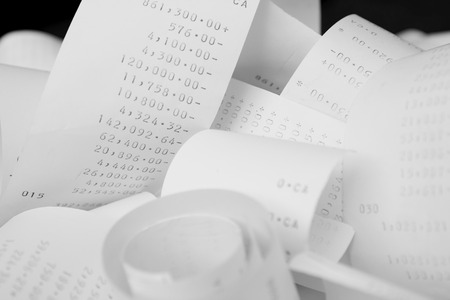 Paper cash register receipts in a lose pile close up with soft focusの写真素材