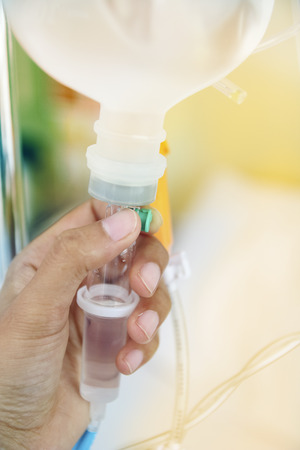 Close up saline IV drip for patient and Infusion pump in hospital.の写真素材